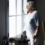 Senior woman standing alone at home
